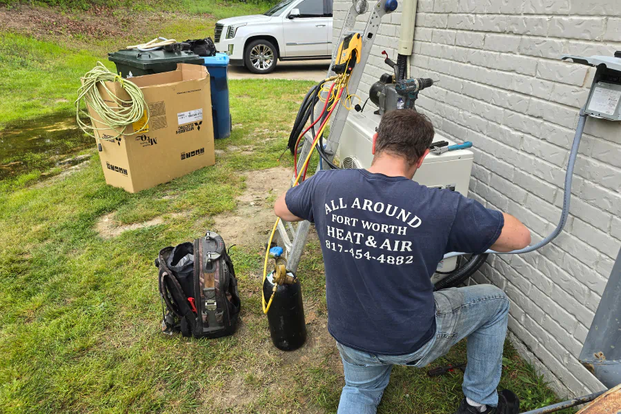 man fixing hvac exterior with tool bag